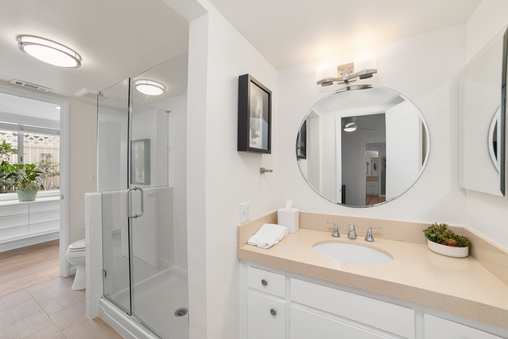 This Jack & Jill ensuite features a single vanity & glass shower