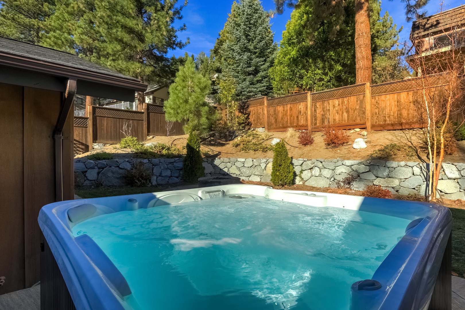 Fenced in backyard with firepit, hot tub, gas BBQ