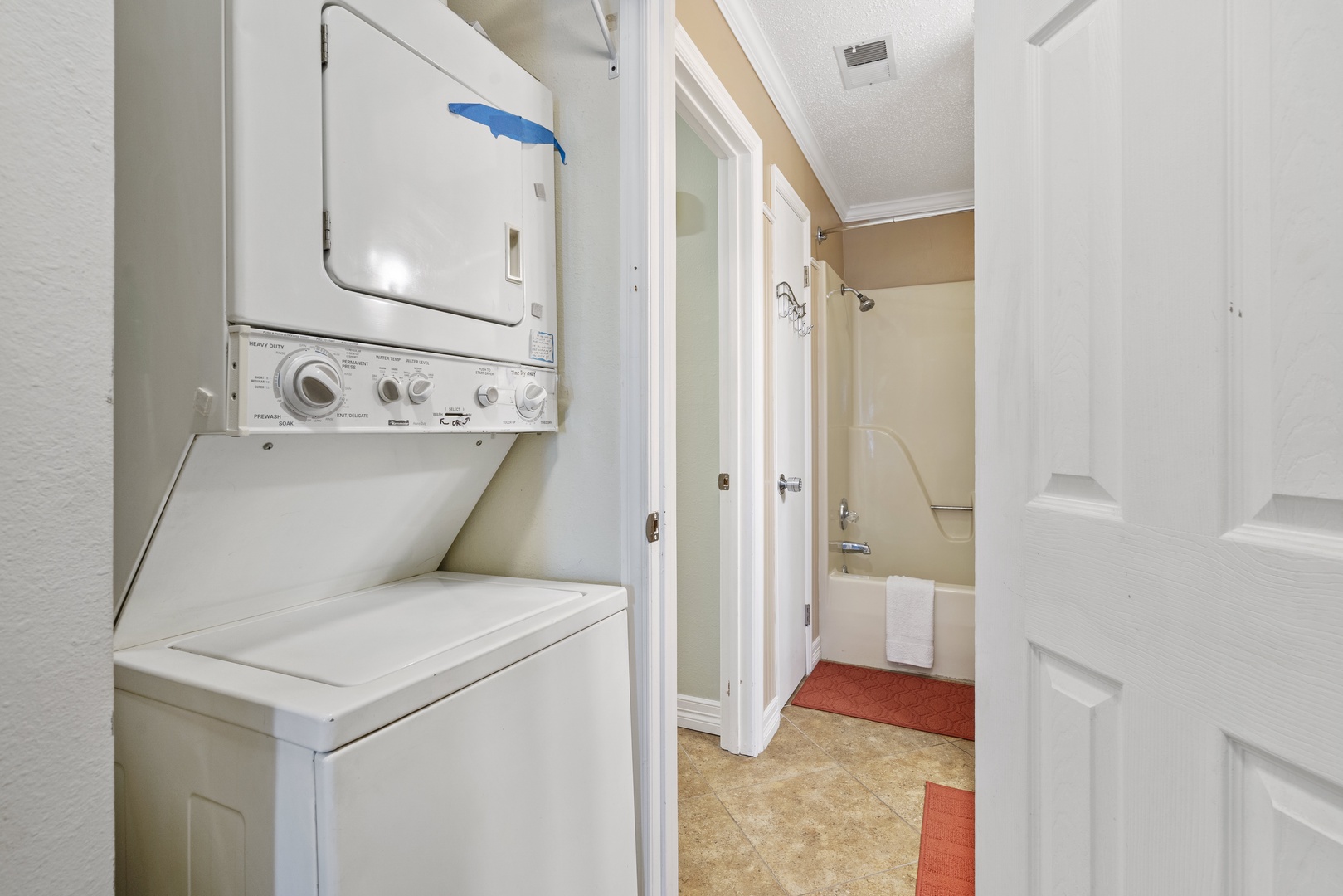 Stackable washer and dryer near bathroom