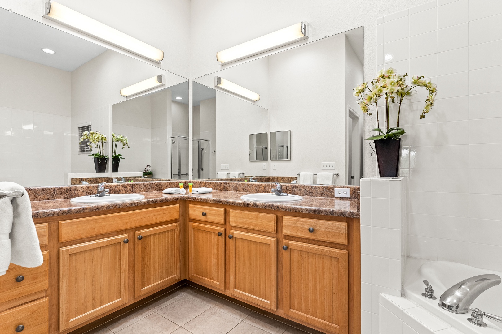 Spacious master ensuite with double vanity, separate soaking tub, and walk-in shower