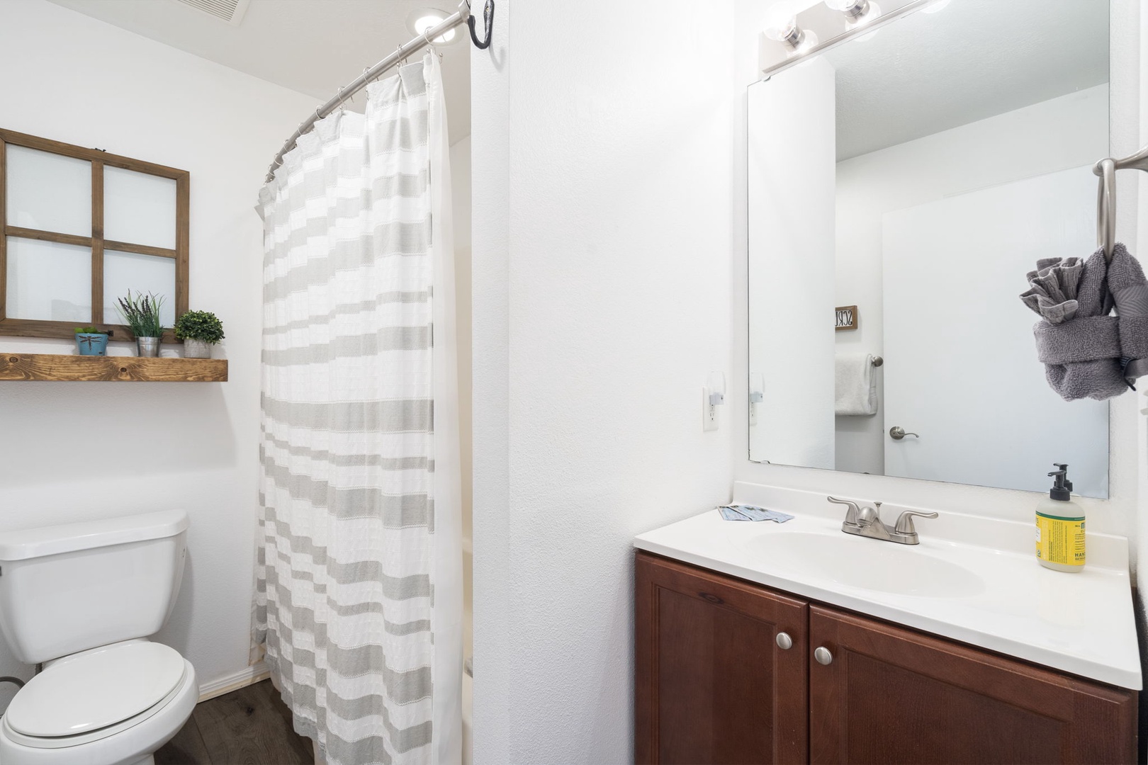 The first of two full bathrooms offers a single vanity & shower/tub combo