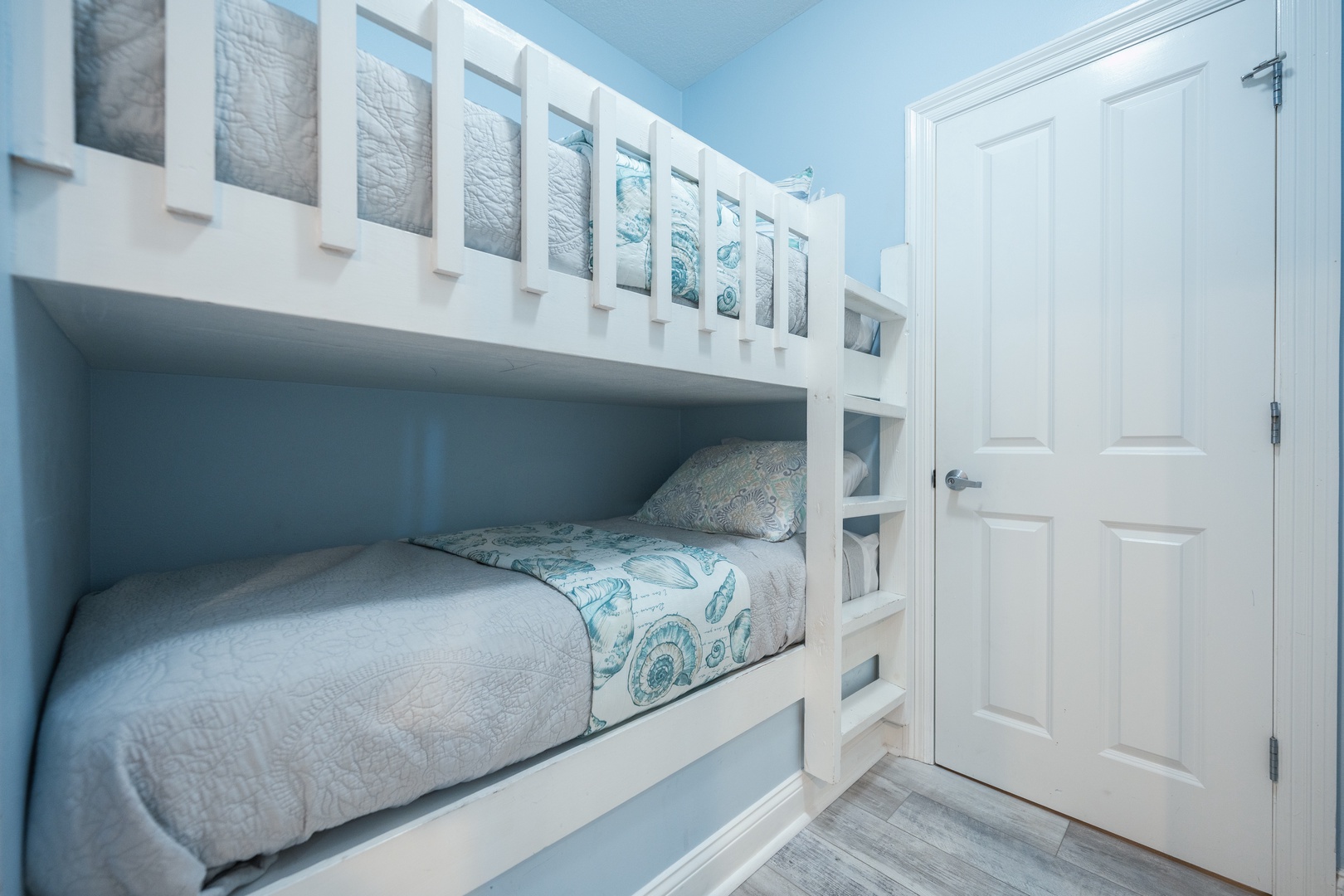 Twin-over-twin bunkbeds are tucked away in the hall alcove