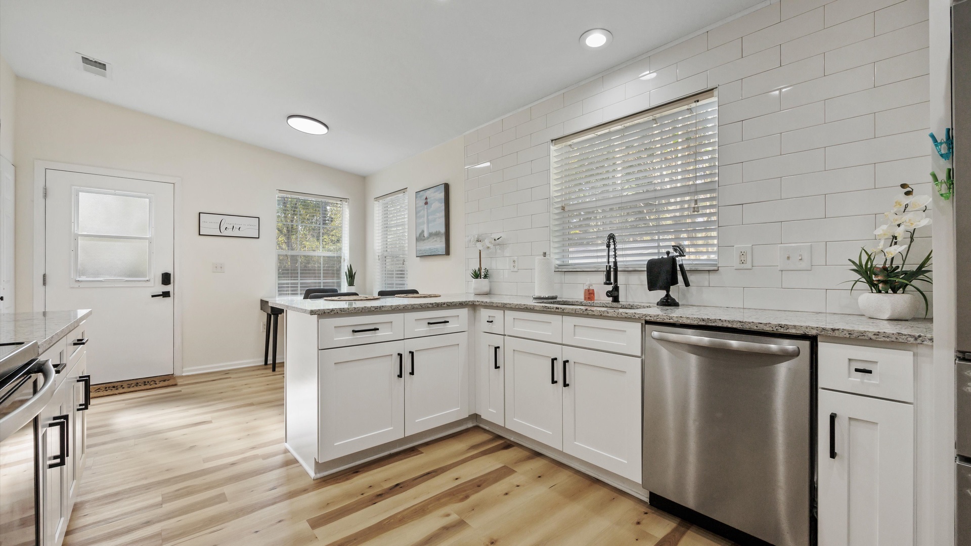 The airy, updated kitchen offers ample space & all the comforts of home