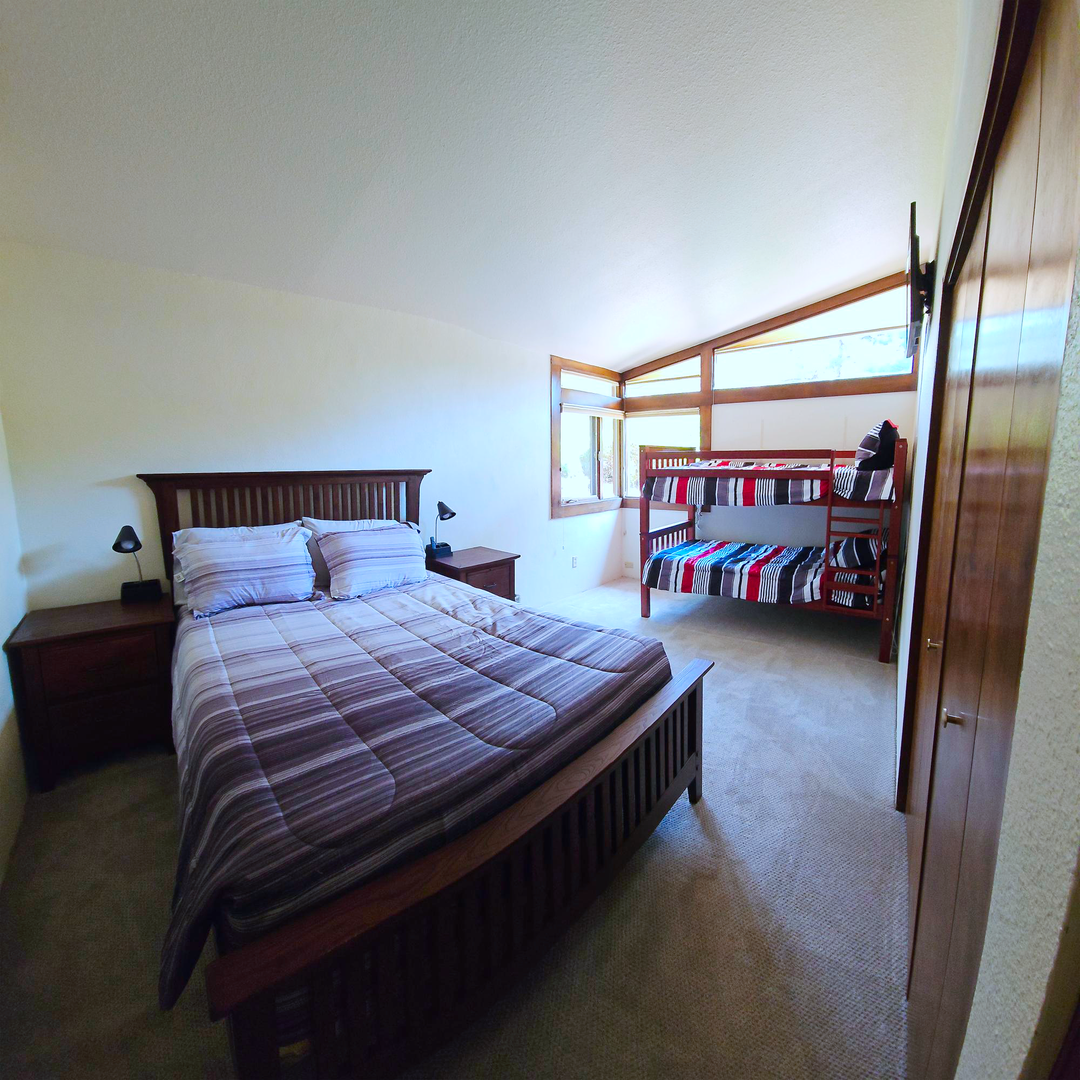 Bedroom 2 with queen bed, twin/twin bunk bed, and Smart TV