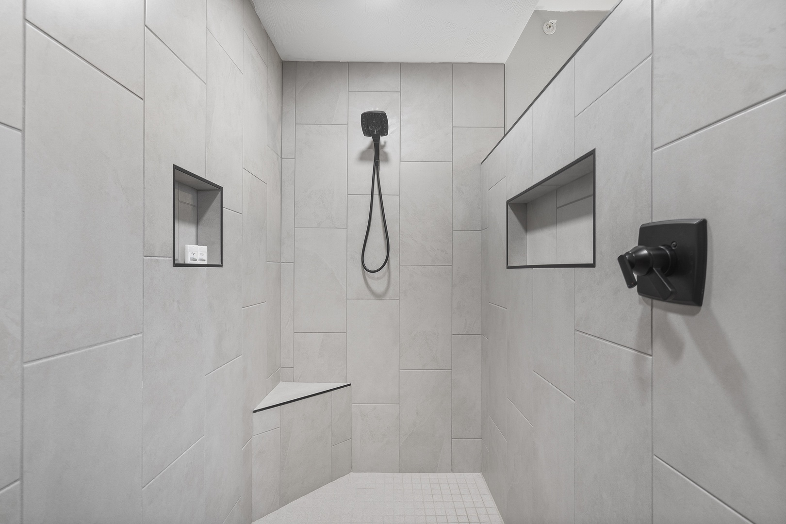 En-suite bathroom with dual sinks, and walk-in shower
