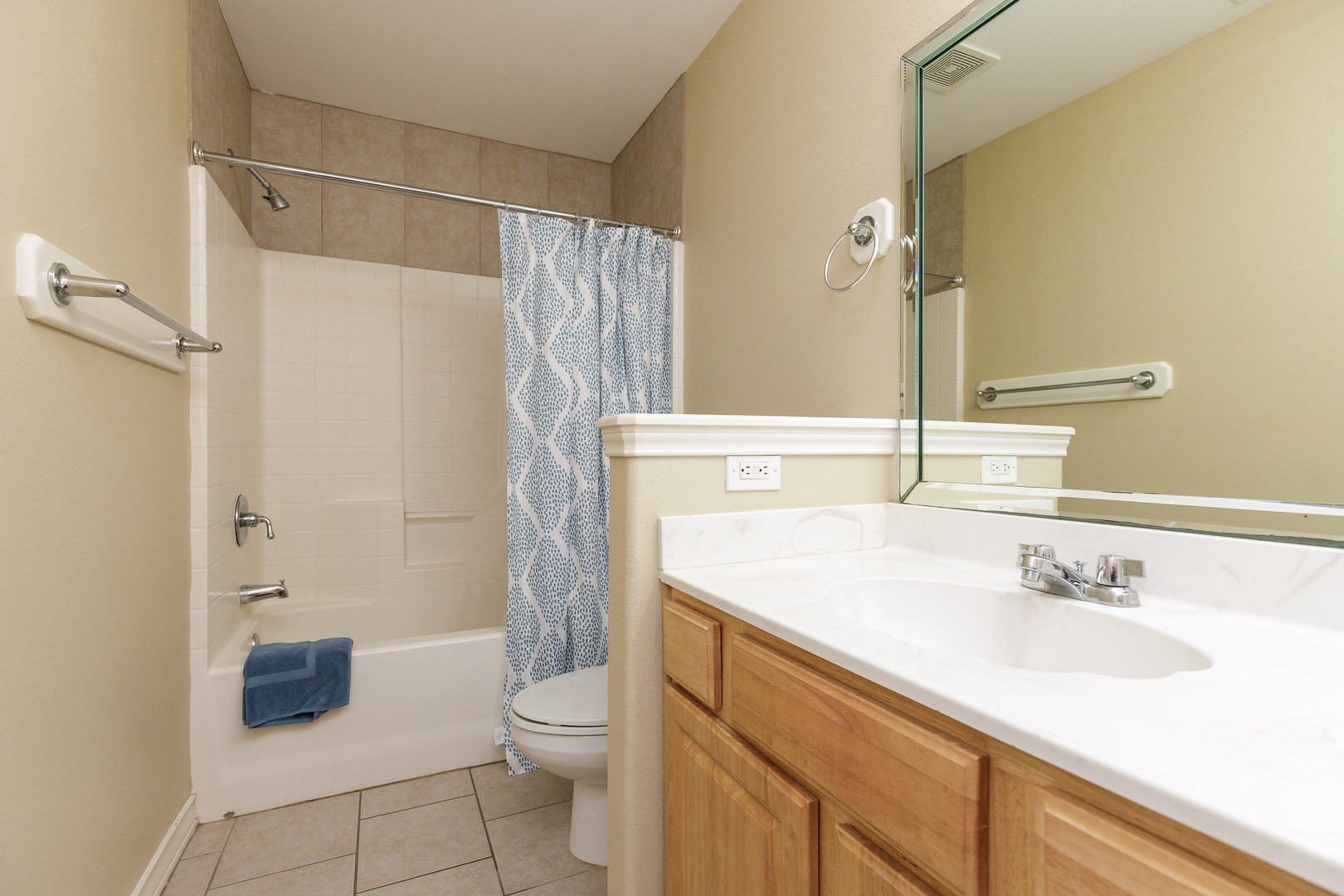 This 3rd-floor ensuite bath includes a single vanity & shower/tub combo