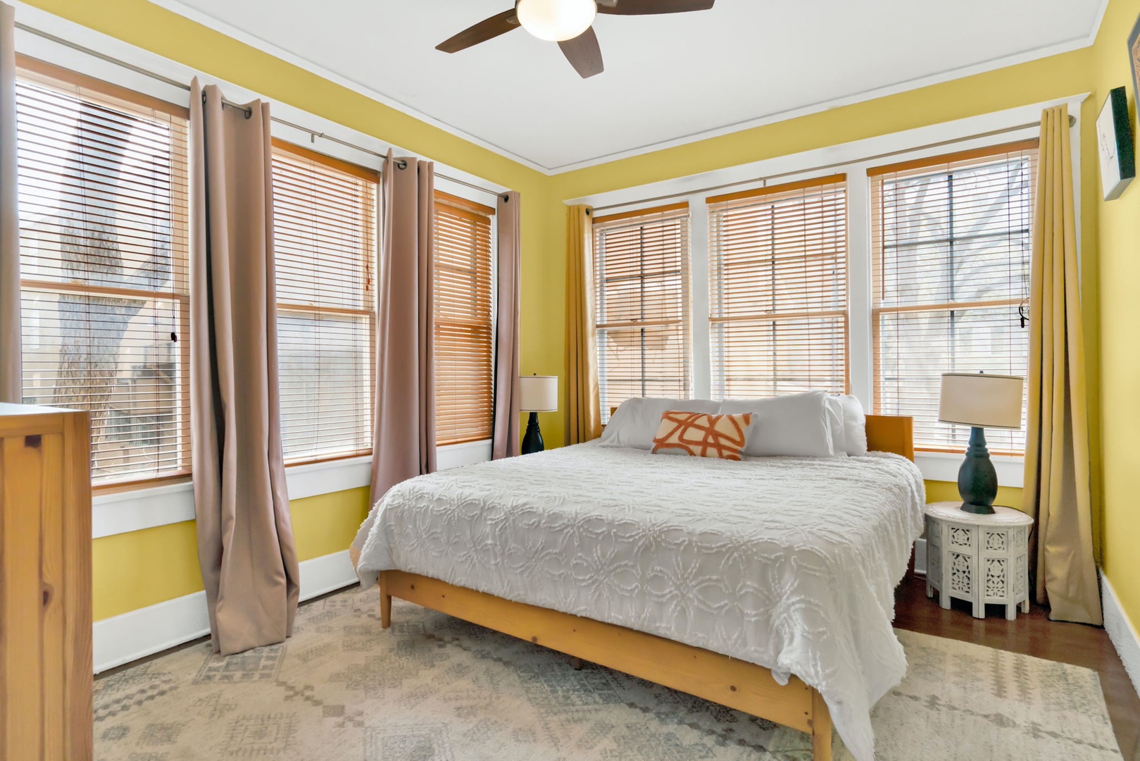 The second bedroom sanctuary features lots of windows & a cozy king bed