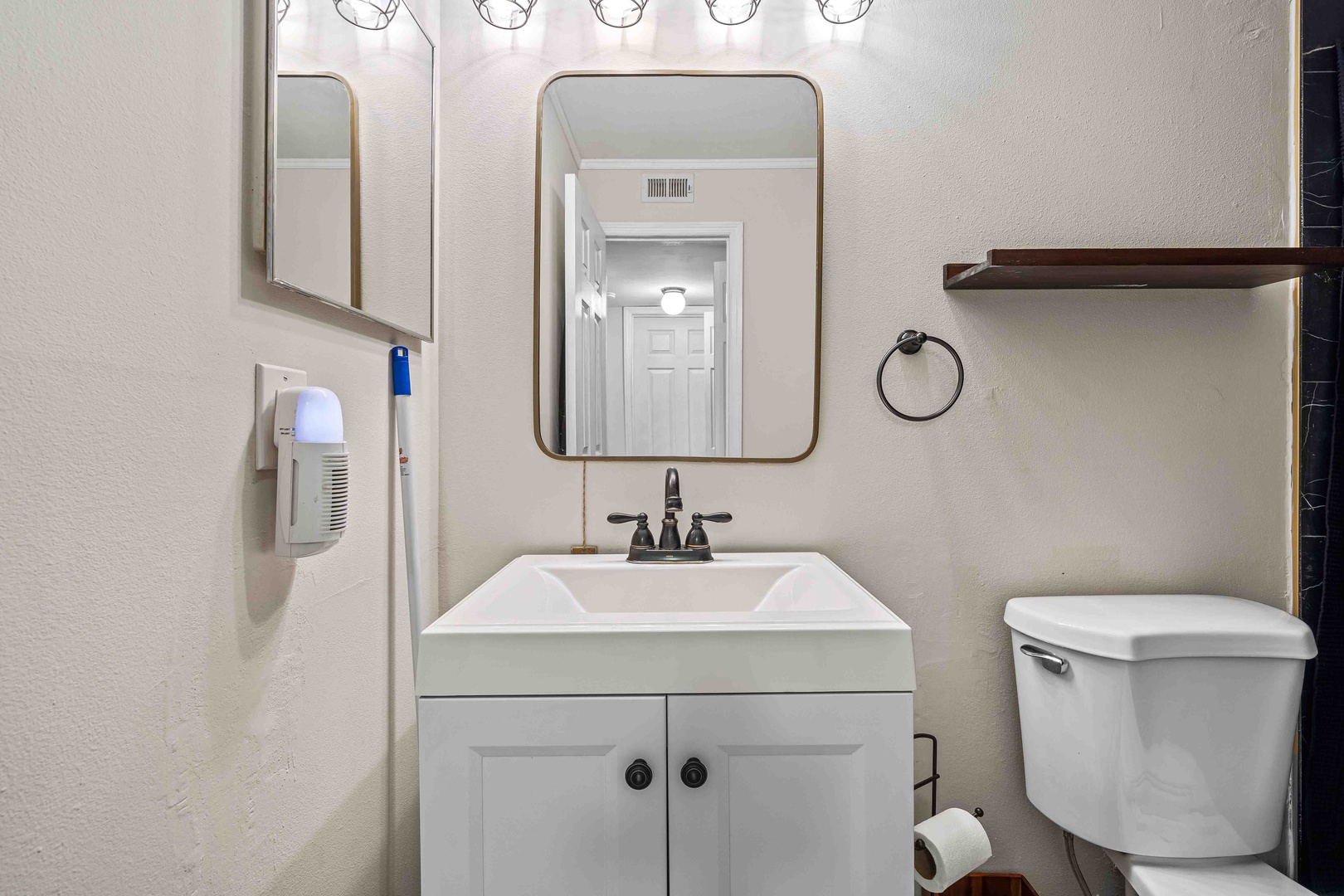 A single vanity, walk-in shower await in the ensuite bath