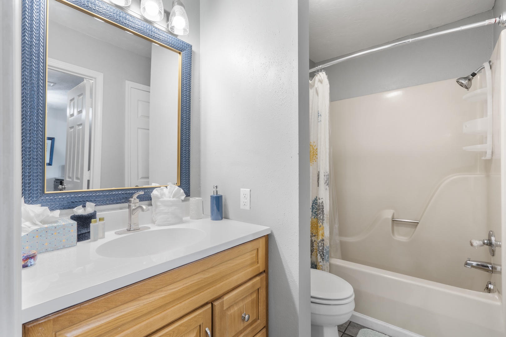 A single vanity & shower/tub combo await in this ensuite bath