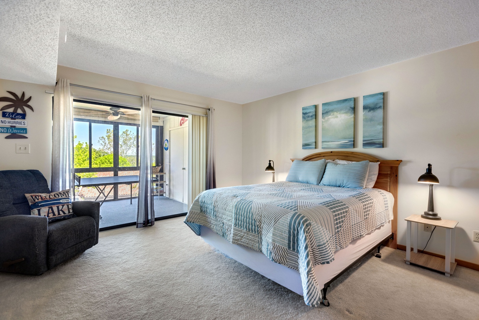 The primary bedroom offers a queen bed, deck access, & a private ensuite