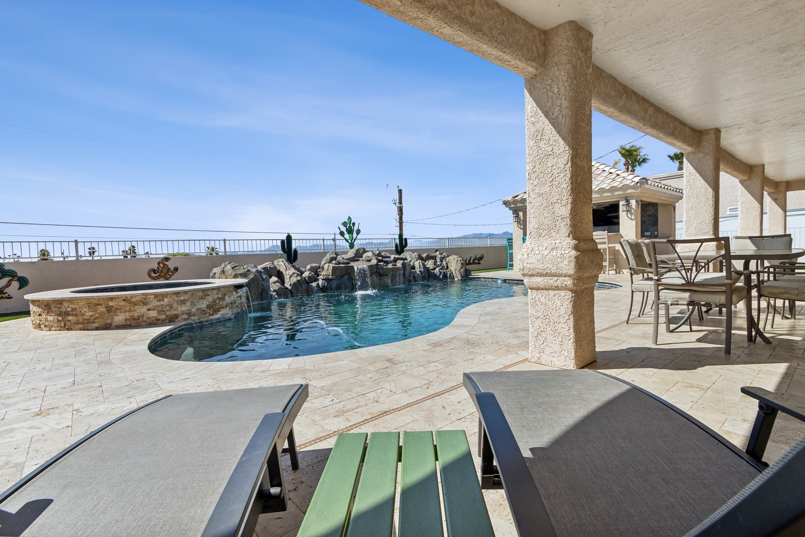 A mountain-view oasis, with a waterfall pool, hot tub, & outdoor kitchen!