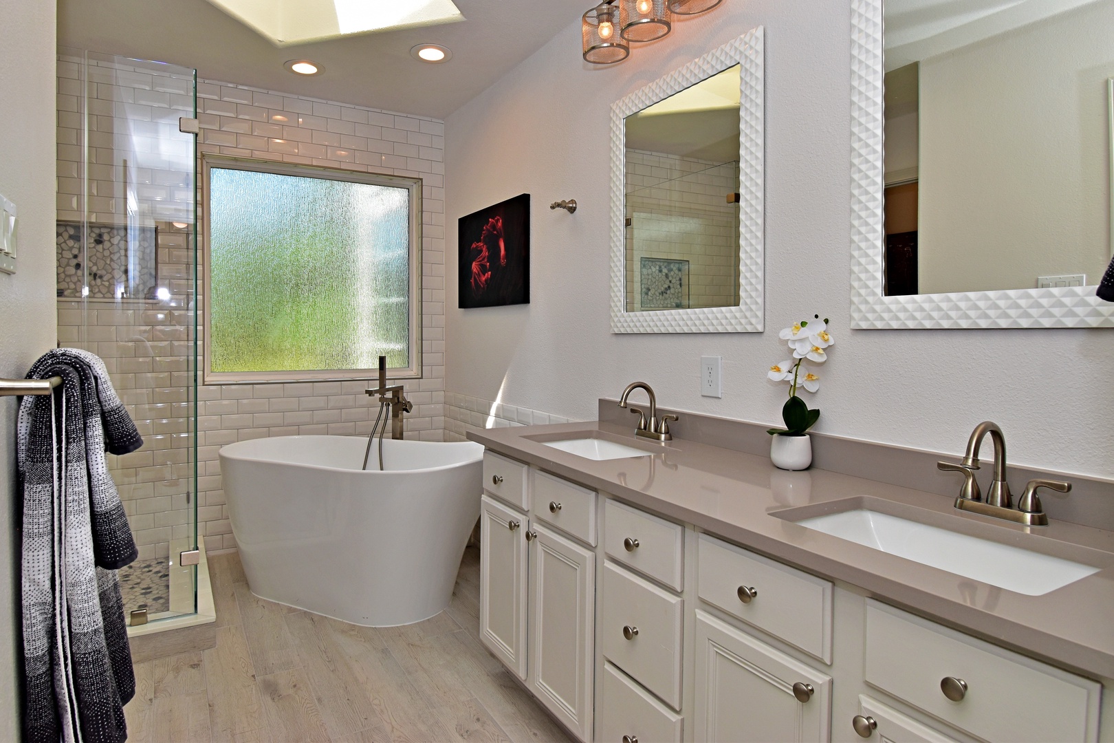 The king ensuite features a dual vanity, glass shower, & luxurious soaking tub