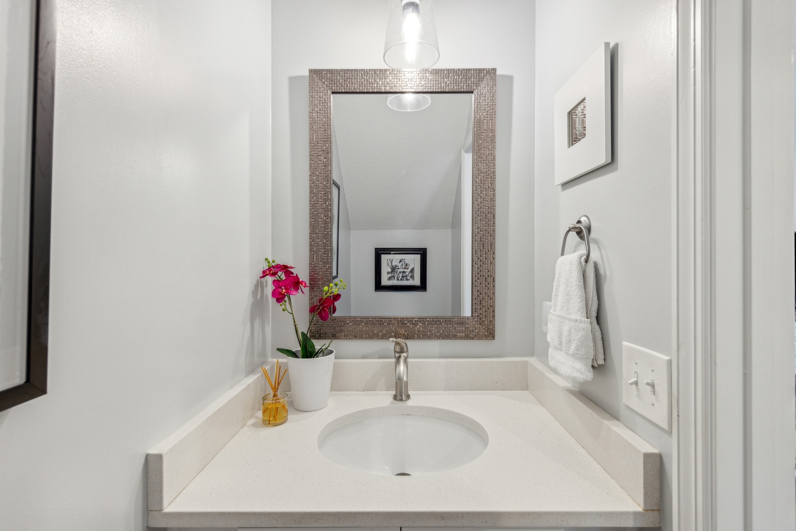 The half-shared bathroom contains a single vanity sink