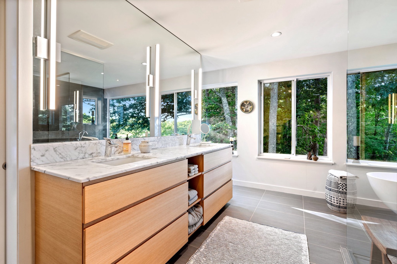 Indulge in a modern bathroom with a walk-in shower, soak tub, and stunning views