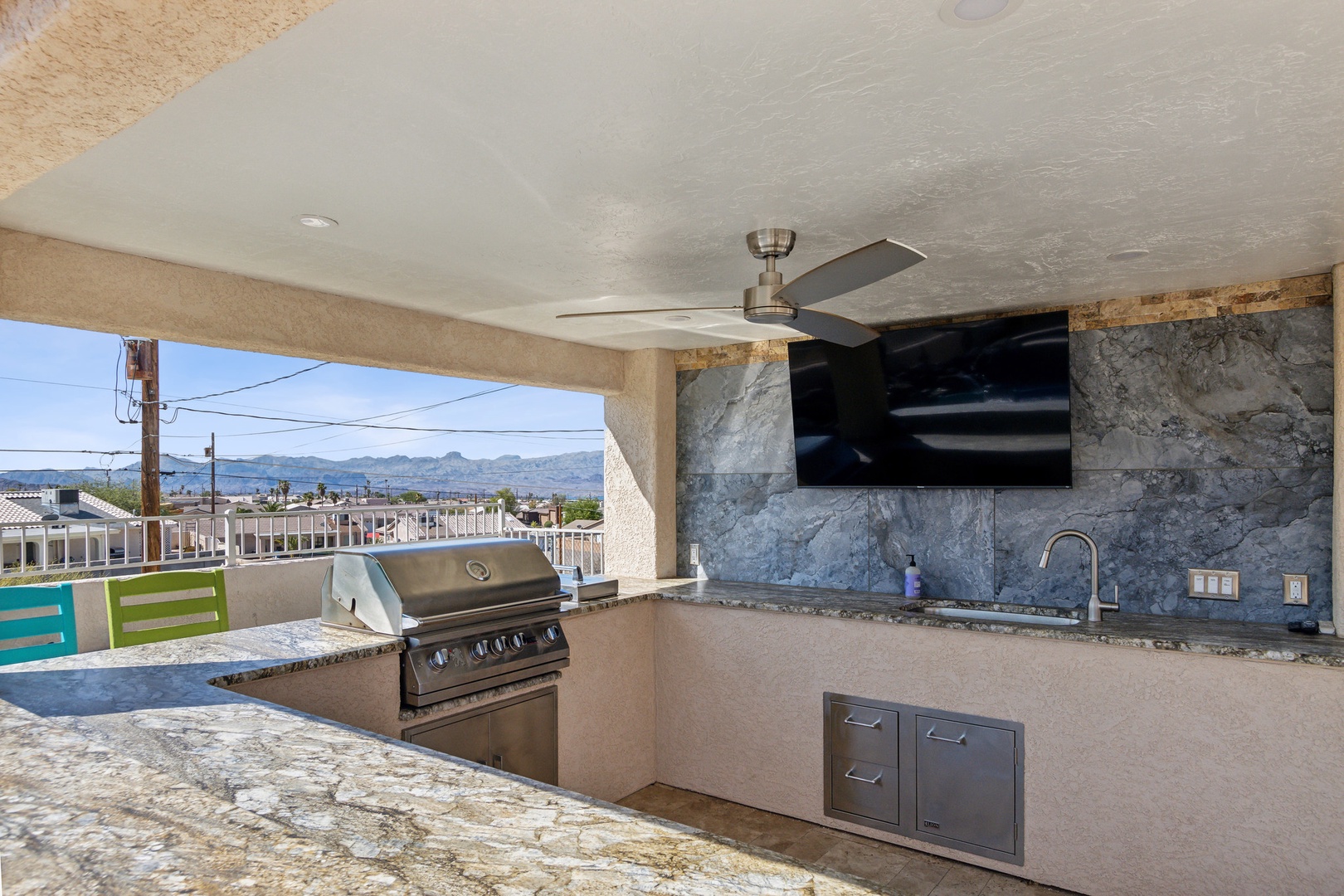 A mountain-view oasis, with a waterfall pool, hot tub, & outdoor kitchen!