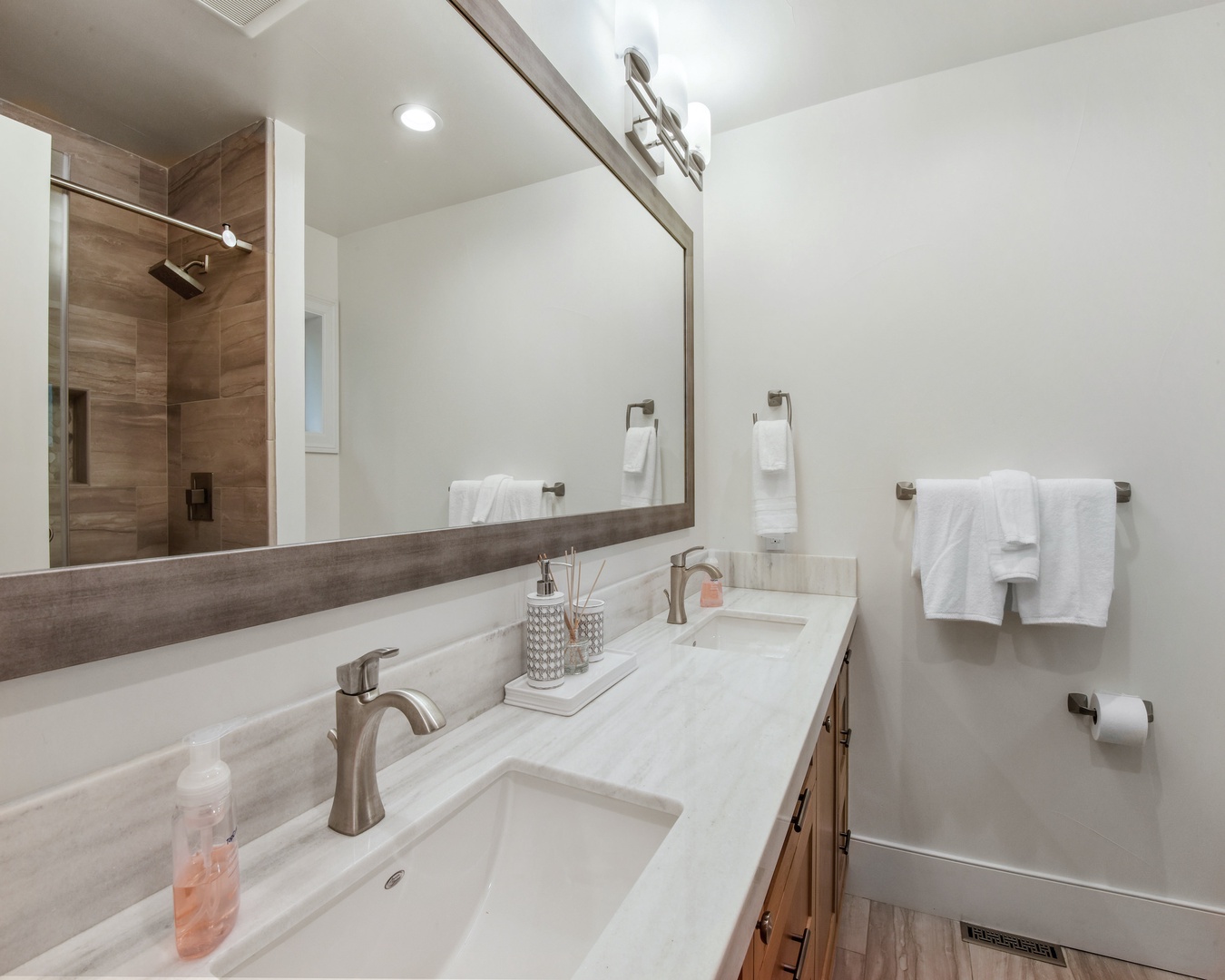 En suite bathroom with dual sinks and standing shower
