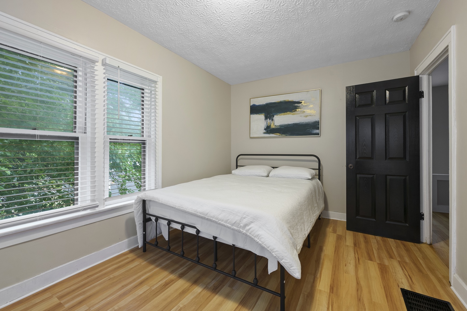 The second bedroom sanctuary includes a plush queen-sized bed