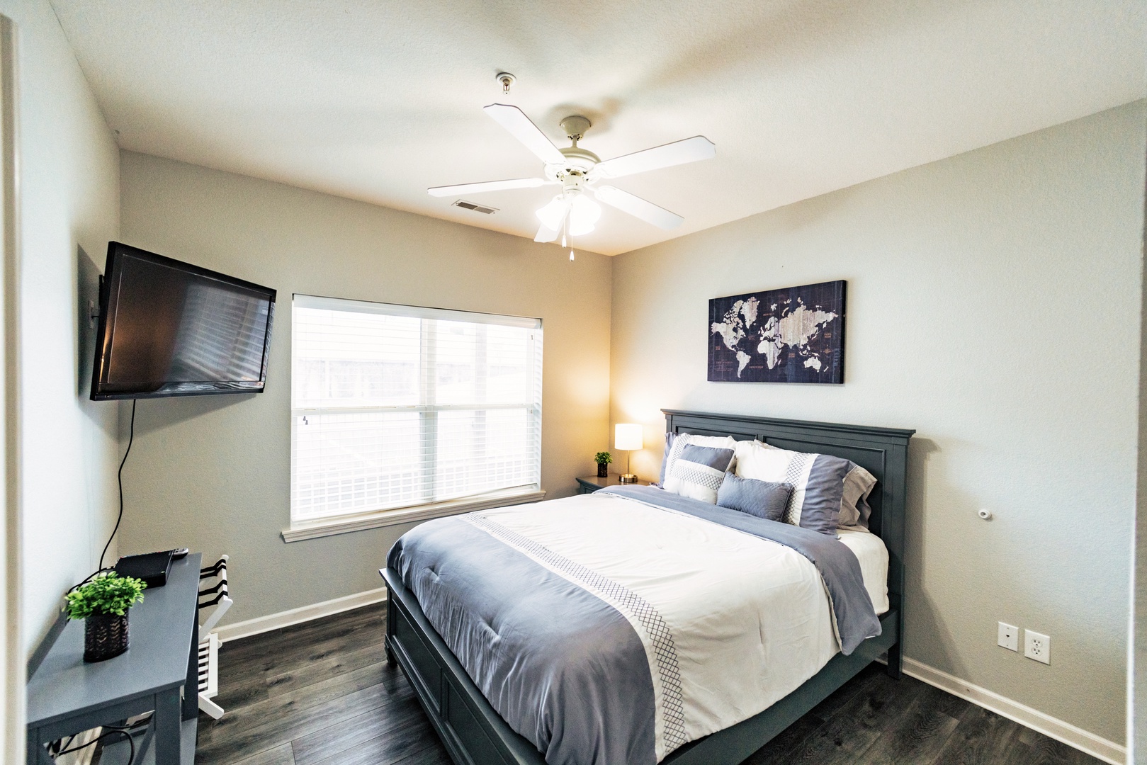 The final serene bedroom offers a queen-sized bed & TV