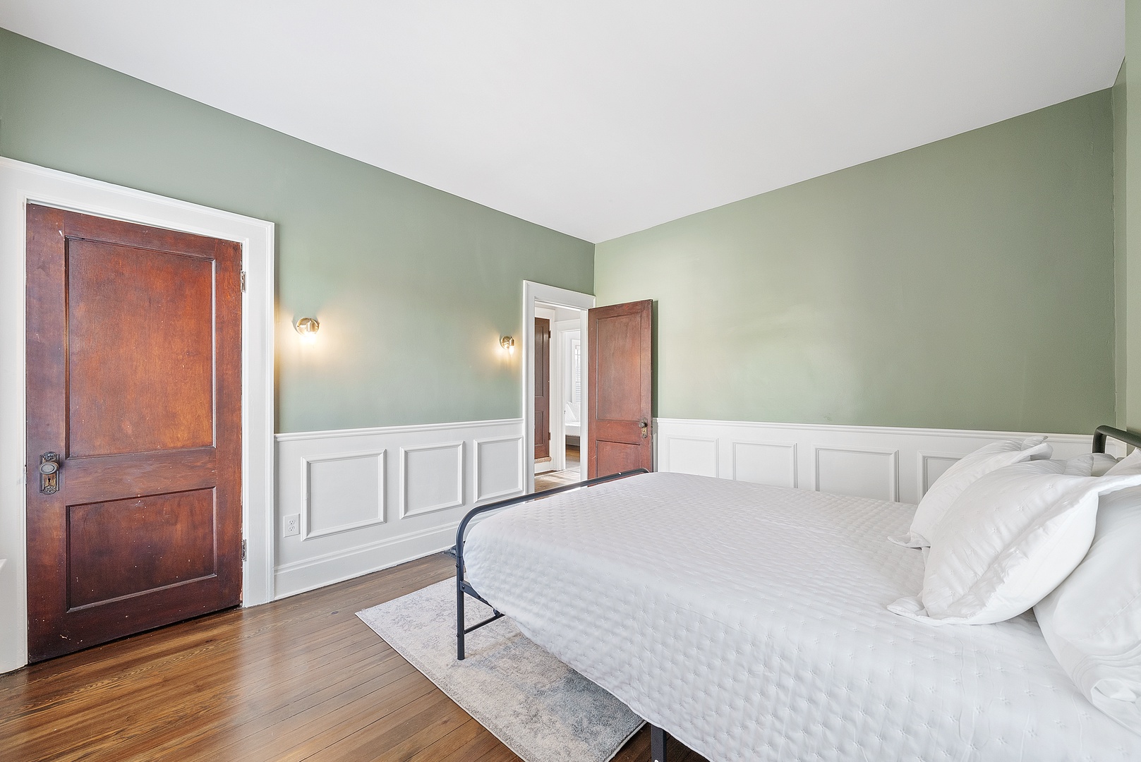 This bedroom on the second floor features a plush queen-sized bed