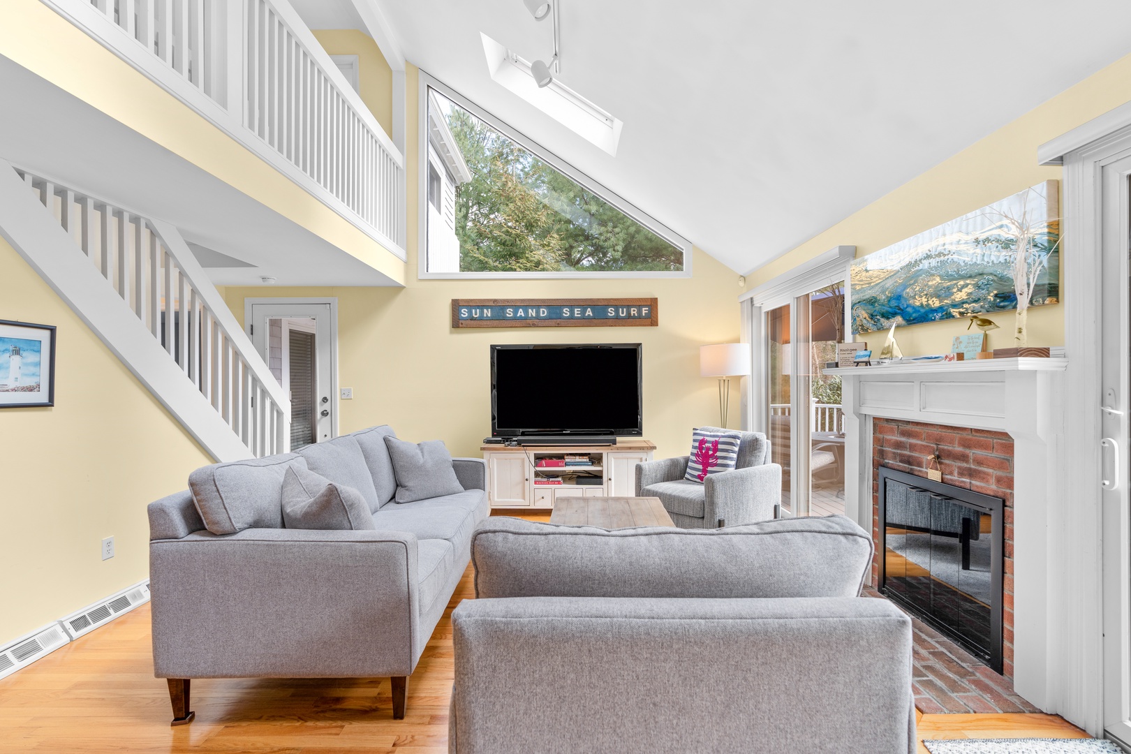 Bright spacious living area with ample seating, and Smart TV