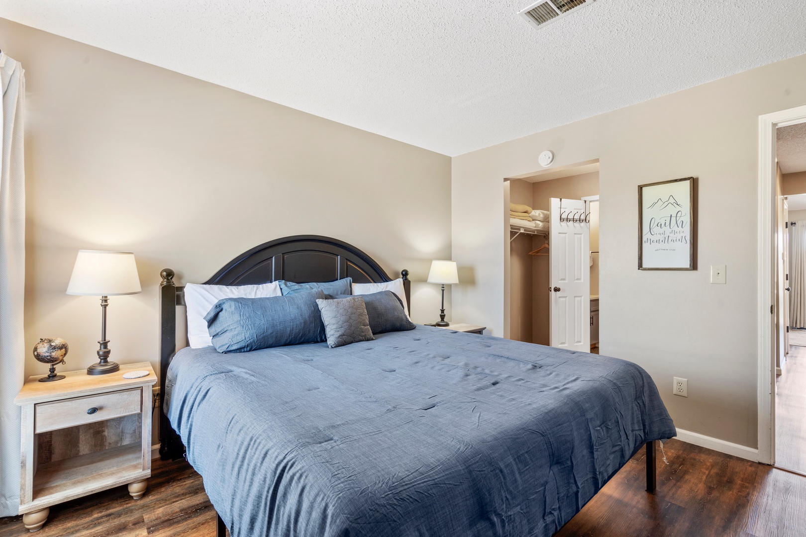 Unit 19’s tranquil primary suite boasts a plush king bed, ensuite, & TV