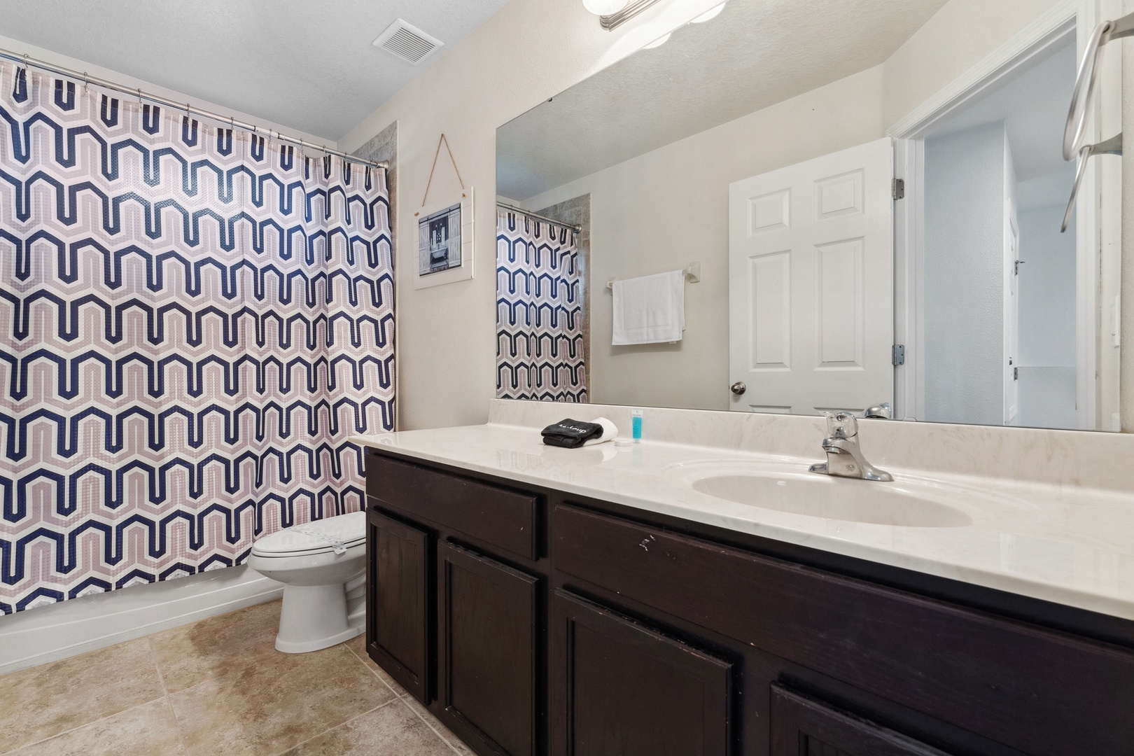 Shared bathroom with shower/tub combo