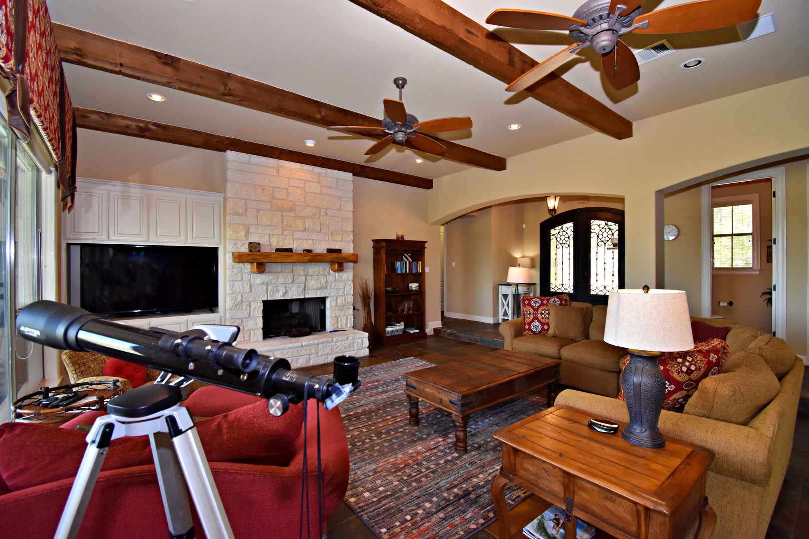 Open living space with lake view, TV, fireplace, and deck access