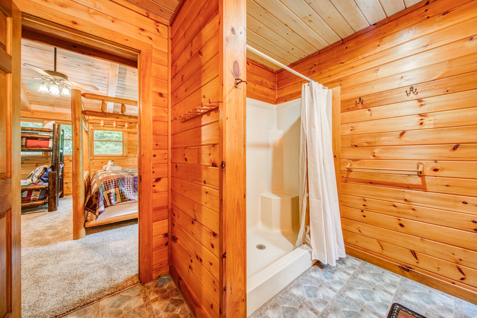 The loft-level bathroom offers a double vanity & walk-in shower