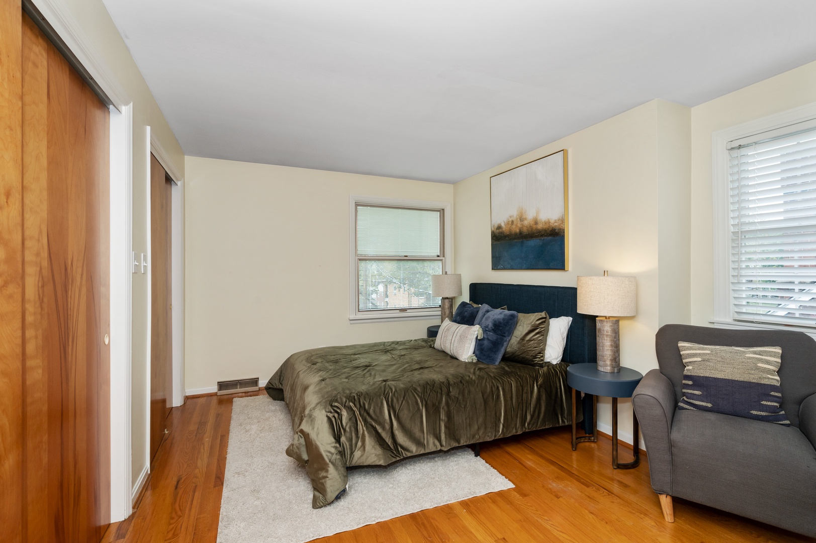 This 2nd floor bedroom offers a queen bed, desk workspace, & chic sitting area