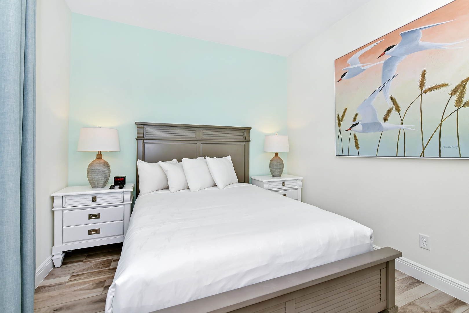 Coastal elegance awaits in this main-level queen bedroom