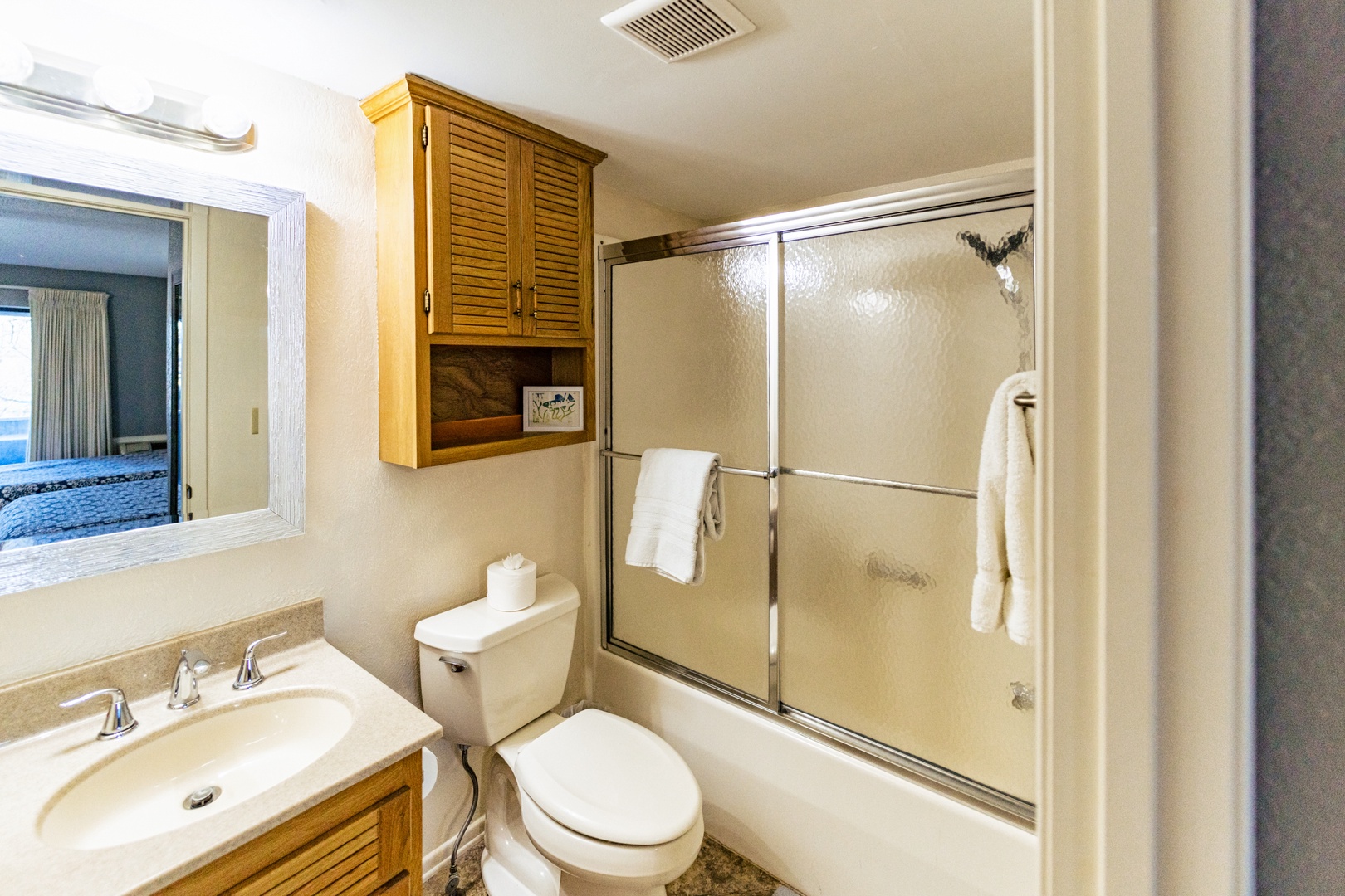 This lower-level ensuite includes a single vanity & shower/tub combo