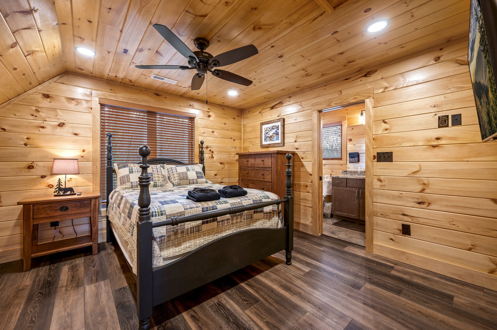 Bedroom 2 with queen bed, TV, and ensuite