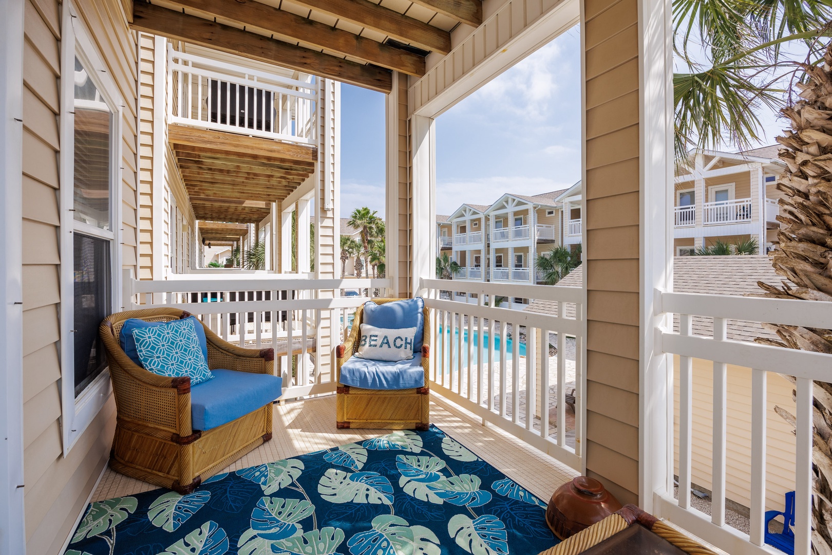 Take a breath of tranquility on the private balcony with pool view