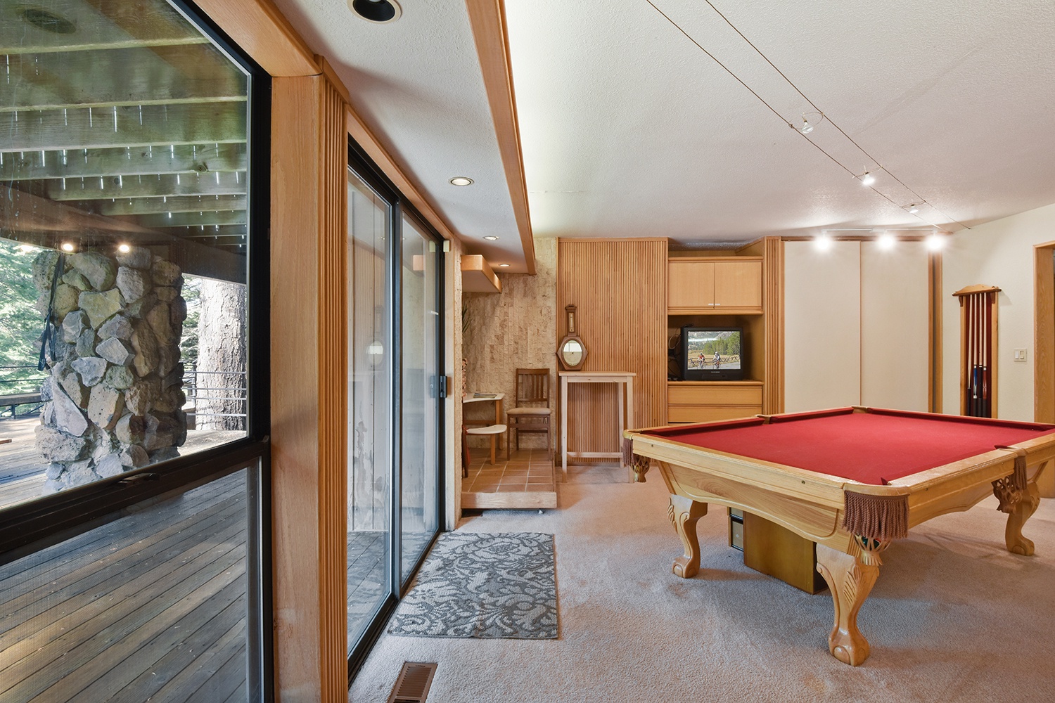 Ground level game room with pool table, and TV