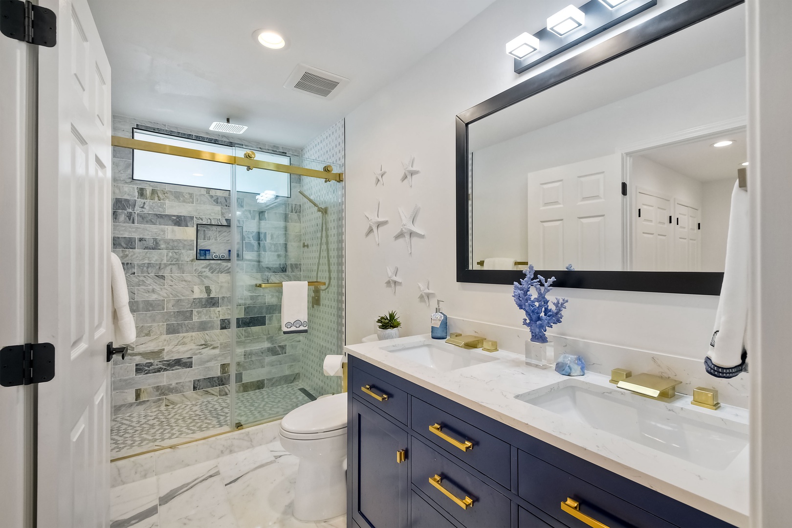 This gorgeous full bath includes a double vanity & luxurious glass shower