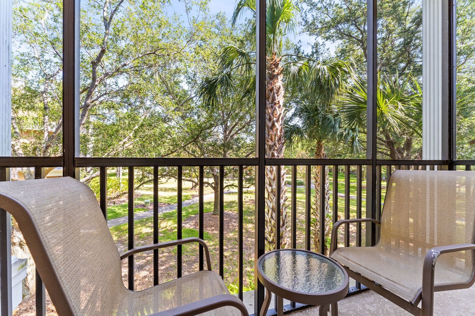 Screened balcony with two chairs, perfect for relaxing & enjoying the fresh air