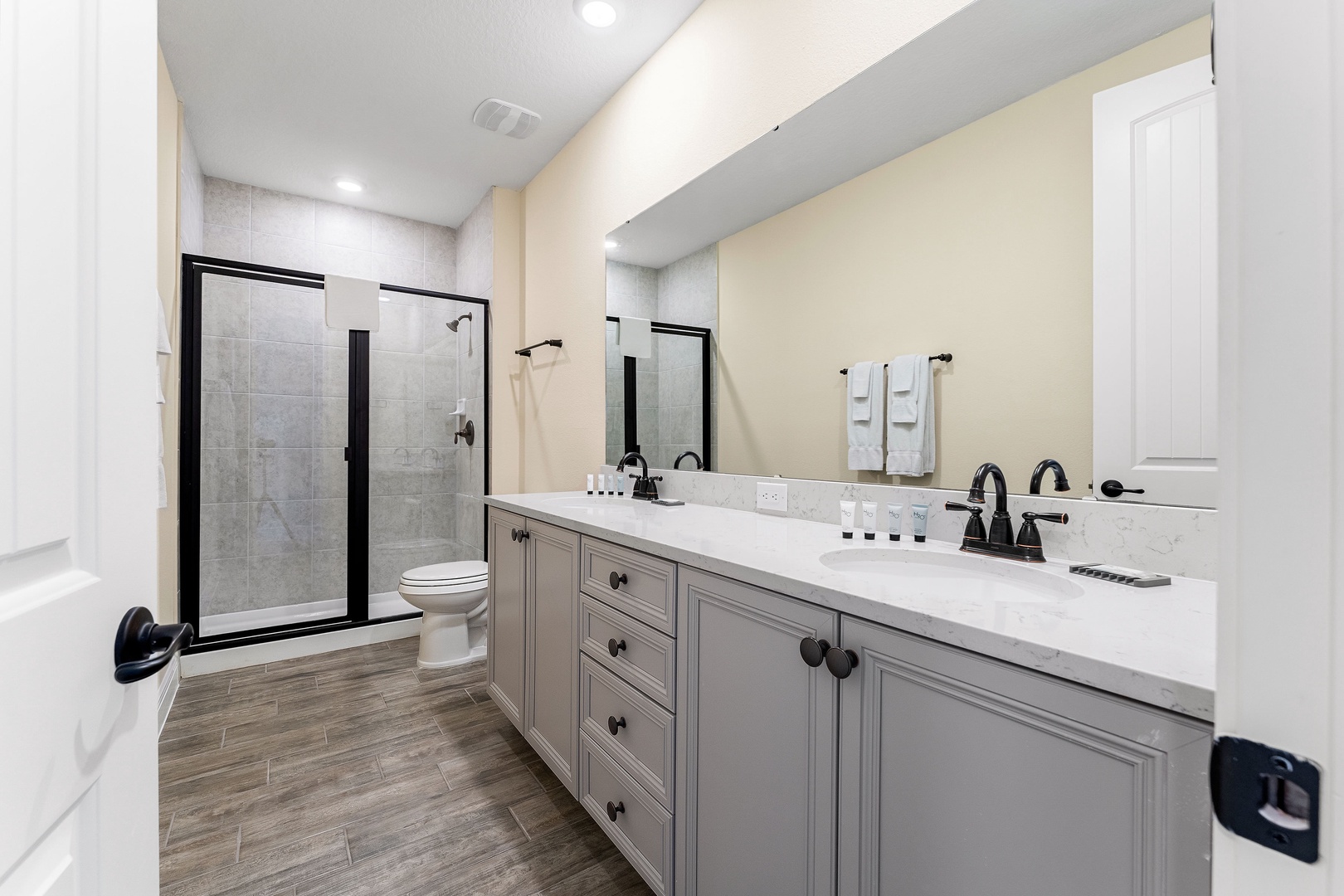 Bathroom 3 en-suite to bedroom 4 located on second floor with dual vanity and glass walk in shower