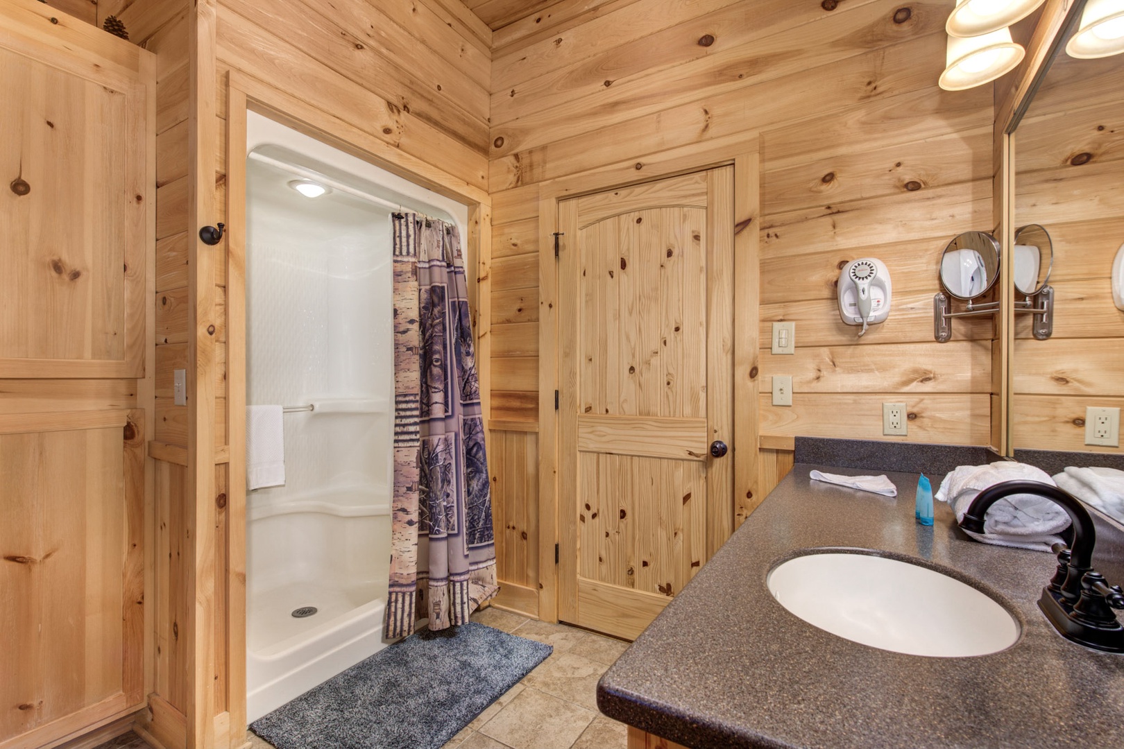 This Jack & Jill ensuite includes a single vanity, soaking tub, & shower