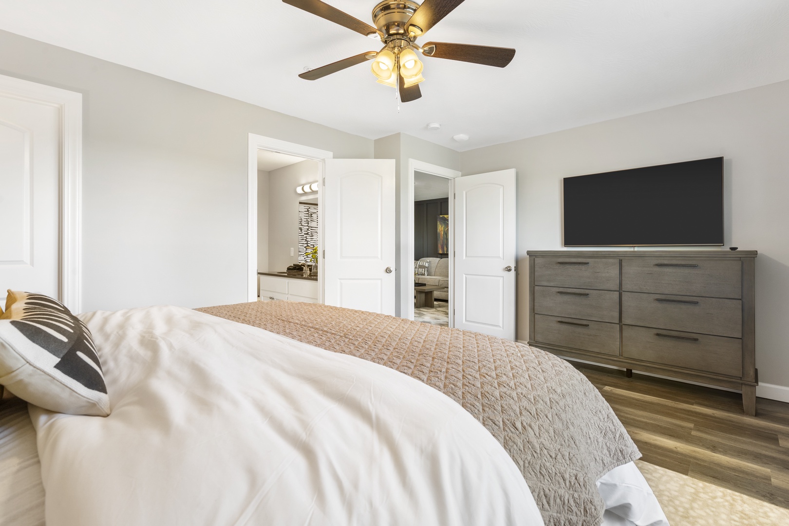 This main-level bedroom sanctuary includes a king bed, smart TV, & ensuite