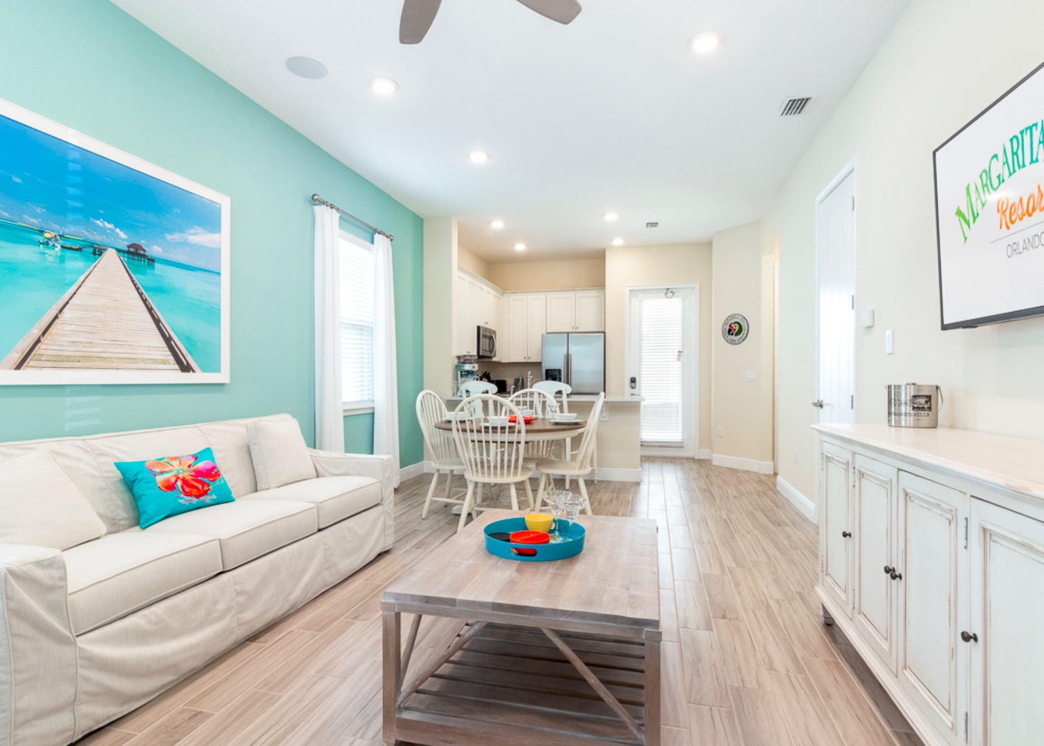 Relax in this bright and airy living space with coastal decor