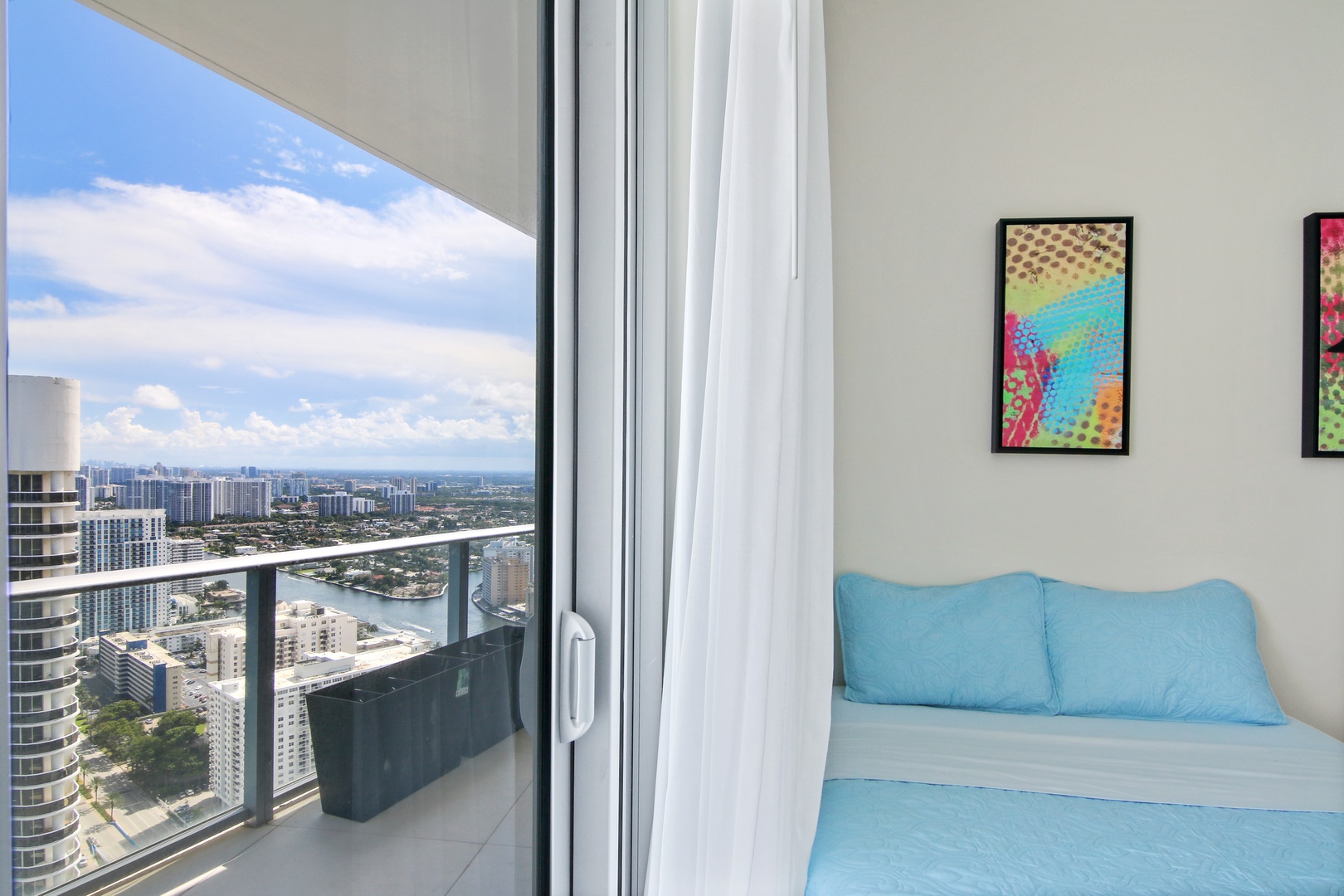 The 1st of 2 double queen bedrooms offers a Smart TV, desk, & balcony access