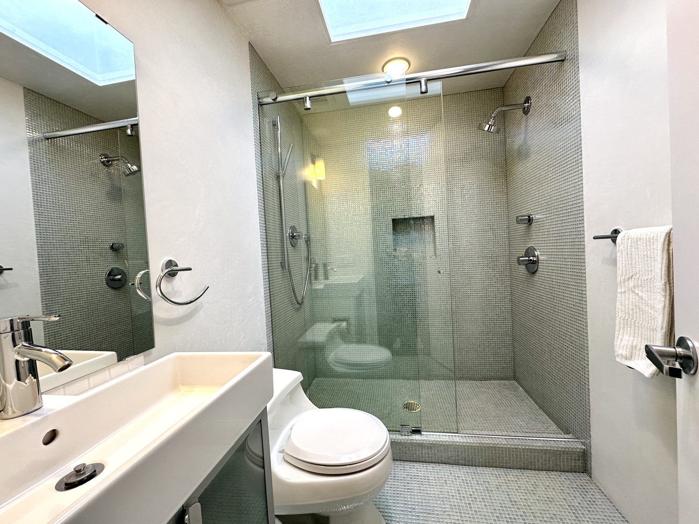 This 2nd-level ensuite offers a single vanity & spa-like glass shower