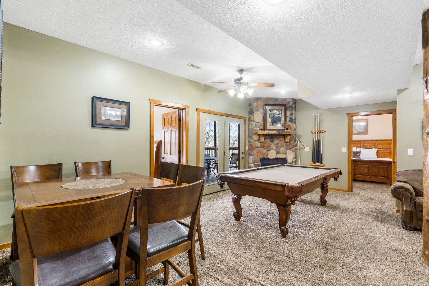 The lower-level game room, with 2 sleeper sofas, pool table, & gaming console