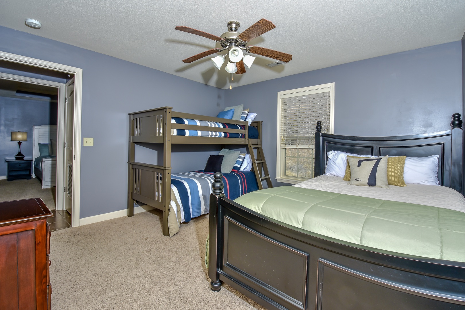 Twin-over-twin bunks, a queen bed, & Smart TV await in the second bedroom