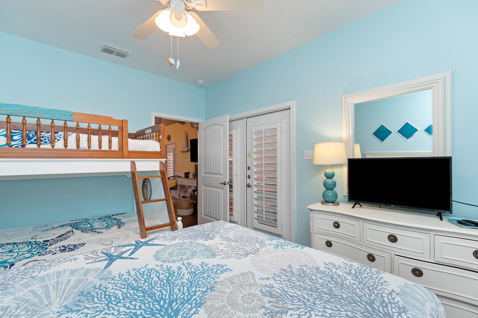 Bedroom 2 with Queen bed, Twin/Full bunk bed, Smart TV, patio access, and en-suite