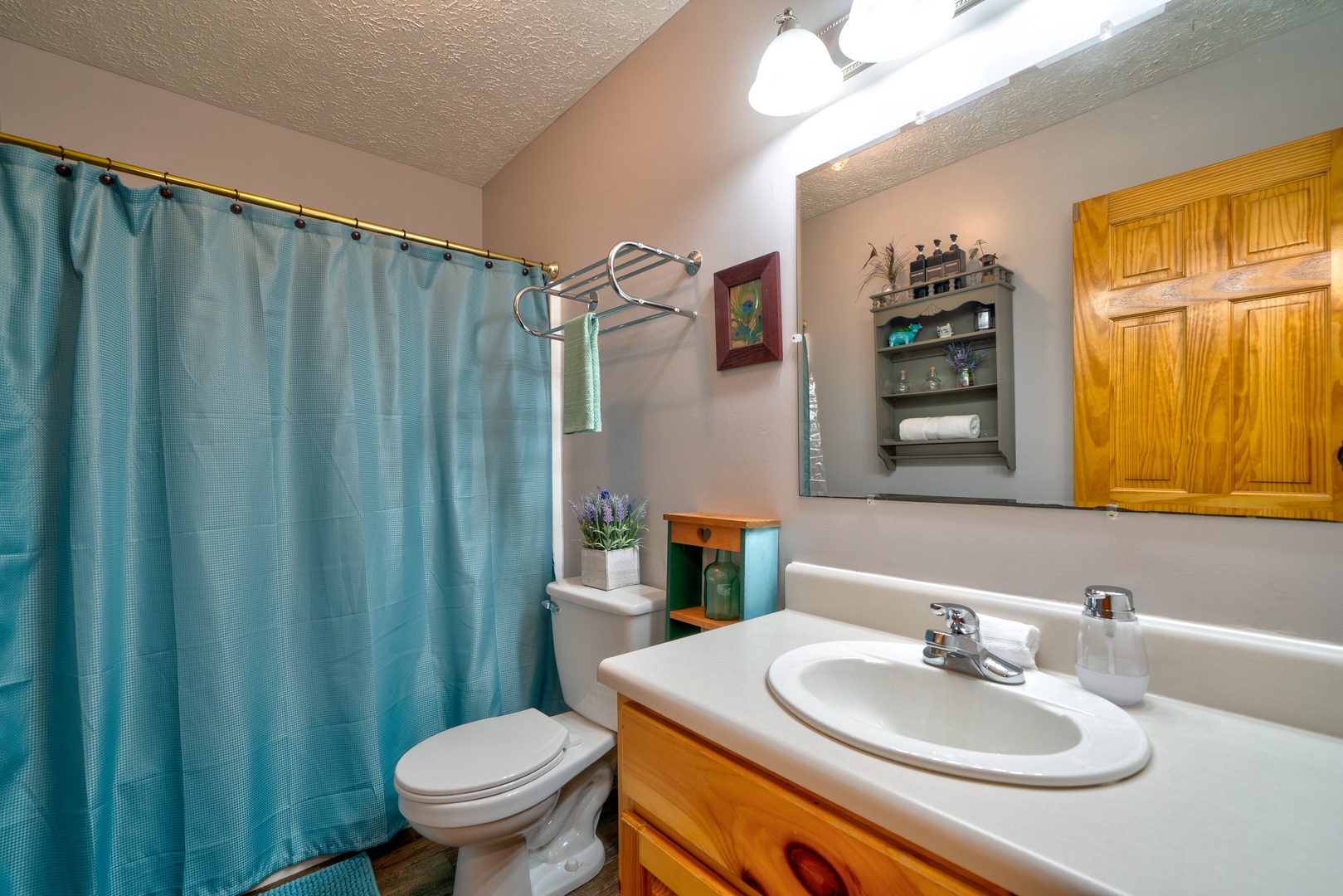 This full bath on the main level offers a single vanity & shower/tub combo