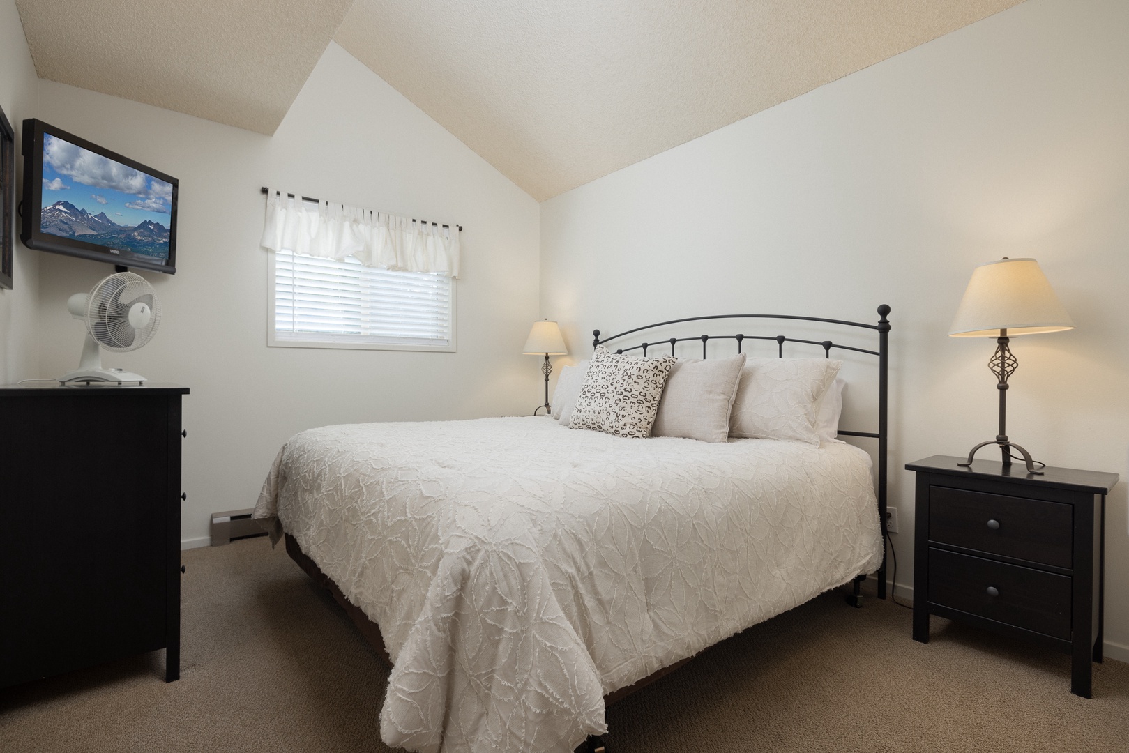 The serene primary bedroom features a king bed, Smart TV & closet