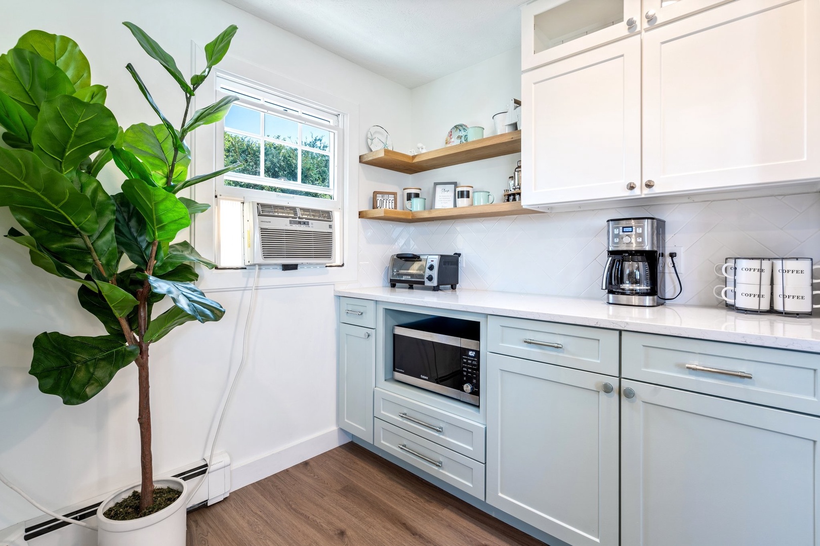 The cozy kitchen offers ample space & all the comforts of home