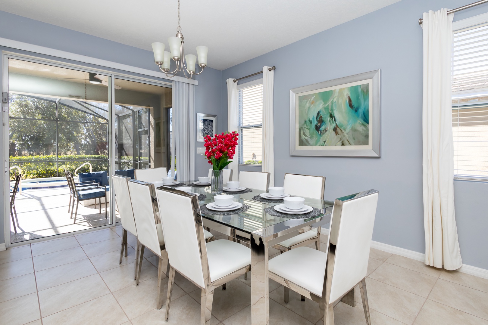 Gather for meals at the dining table with a waterfront view, seating for 8