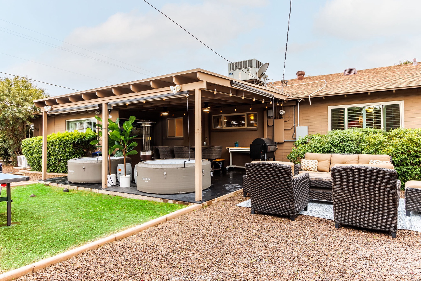 Patio with hot tub, outdoor dining, and gas BBQ grill